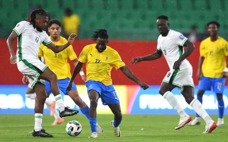 Nigeria players celebrate victory over Gabon in CAF playoff.